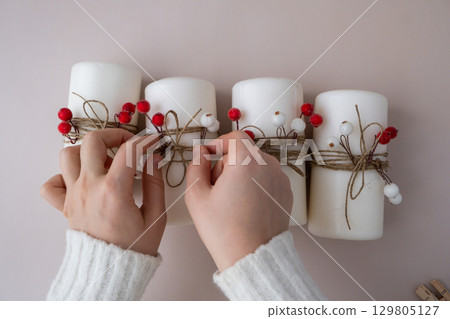 DIY process of woman making Christmas arrangement of advent candle calendar four weeks. Series of handmade craft instruction. Zero waste eco-friendly winter holiday decoration. New year DIY process of woman making Christmas arrangement of advent candle calendar four weeks. Series of handmade craft instruction. Zero waste eco-friendly winter holiday decoration. New year 129805127