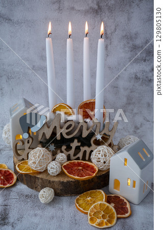 Merry Christmas wooden message New year and Christmas preparation. Four-week advent candles on table. Handmade eco-friendly decor. Sustainable Christmas decoration 129805130