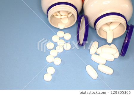 White Pills and Tablets on Blue 129805365