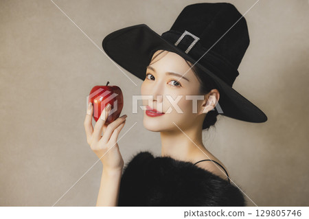 A woman who costumes Halloween 129805746