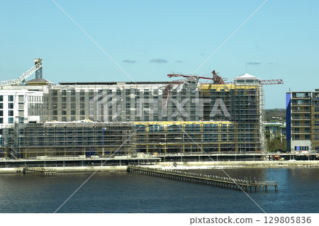Aerial view of ruined by hurricane Ian construction crane on high apartment building site in Port Charlotte, USA Aerial view of ruined by hurricane Ian construction crane on high apartment building site in Port Charlotte, USA 129805836