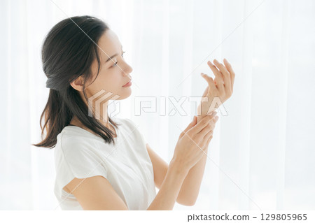 Women painting hand cream Women painting hand cream 129805965