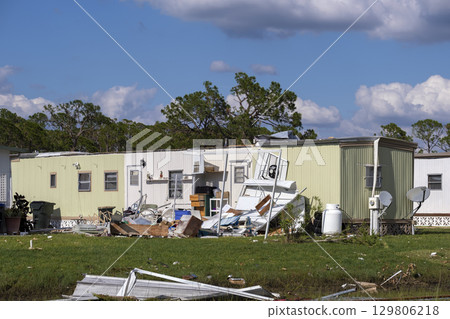 Collapsed and damaged mobile homes after hurricane swept through Florida residential area. Consequences of severe natural disaster 129806218