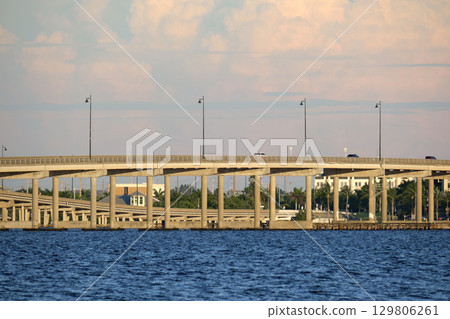 Barron Collier Bridge and Gilchrist Bridge in Florida with moving traffic. Transportation infrastructure in Charlotte County connecting Punta Gorda and Port Charlotte over Peace River 129806261