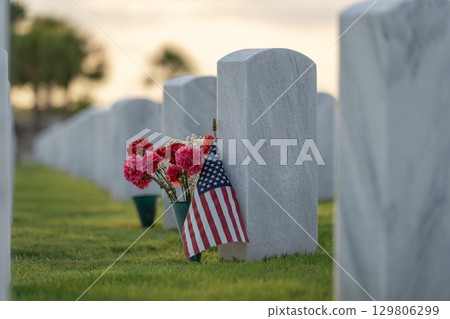 American army Sarasota National Cemetery with rows of white tombstones with USA flags and flowers. Memorial Day concept 129806299