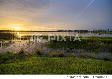 Evening landscape over lake water in southern tropical wetlands. Amazing Florida nature at sunset 129806312
