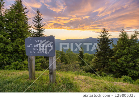 Road trip travel in Appalachian mountains at sunset. Mt. Mitchell Overlook on parkway and woods nature in summer season. Colorful forest in North Carolina 129806323