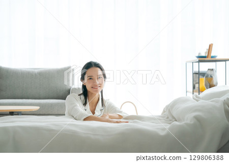 A woman relaxing in her pajamas 129806388