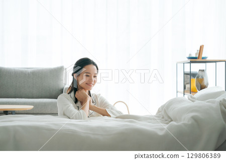 A woman relaxing in her pajamas 129806389