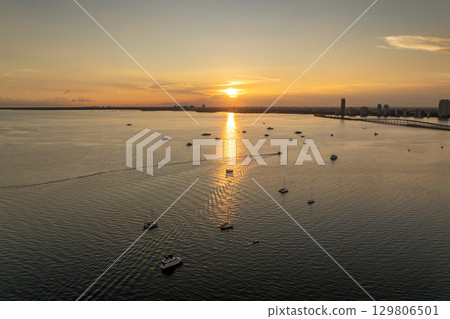 Biscayne Bay harbor with many yachts and fishing boats in Miami, Florida. Enjoying sunset over city skyline with skyscraper buildings in downtown Biscayne Bay harbor with many yachts and fishing boats in Miami, Florida. Enjoying sunset over city skyline with skyscraper buildings in downtown 129806501