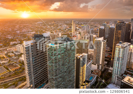 Urban landscape of downtown district of Miami Brickell in Florida, USA. Sunset skyline with high skyscraper buildings in modern American city Urban landscape of downtown district of Miami Brickell in Florida, USA. Sunset skyline with high skyscraper buildings in modern American city 129806541
