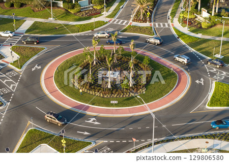 Roundabout crossroads on American city street with moving traffic cars. Circular transportation crossroads in USA 129806580