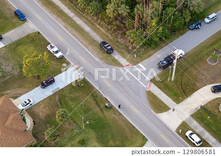 Tow company workers cleaning scattered debris and spilled fluids with sand at car accident site in Florida Tow company workers cleaning scattered debris and spilled fluids with sand at car accident site in Florida 129806581