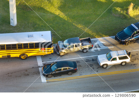 Car accident on city street in Florida. School bus and truck collision. Result of distracted driving and speeding. Emergency services at vehicle crash in USA Car accident on city street in Florida. School bus and truck collision. Result of distracted driving and speeding. Emergency services at vehicle crash in USA 129806590