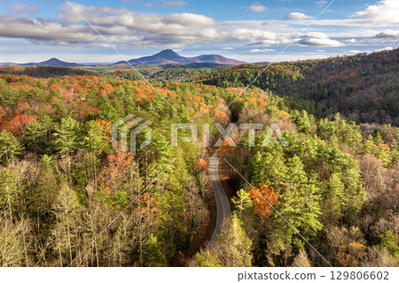 Peaceful mountain road in North Carolina during peak fall season at sunset. Appalachian landscape filled with vivid autumn colors 129806602