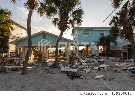 Ruined buildings in need of demolition or repair. Storm surge water and wind damaged houses roof and collapsed walls after hurricane in Florida Ruined buildings in need of demolition or repair. Storm surge water and wind damaged houses roof and collapsed walls after hurricane in Florida 129806613