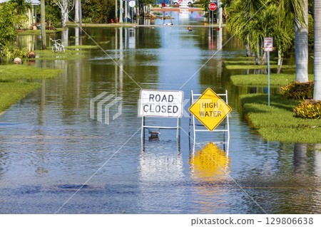 Hurricane Milton aftermath in Punta Gorda, Florida. City street closed because of flooding with warning signs blocking driving of cars 129806638