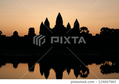 Angkor Wat silhouette in the morning sun Angkor Wat silhouette in the morning sun 129807965