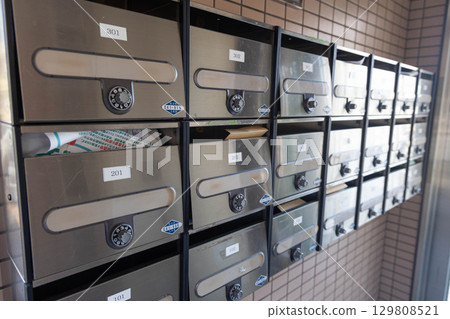 Dial-type mailbox in an apartment building 129808521