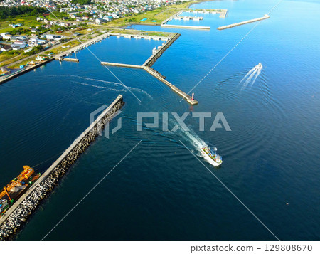Aerial view of fishing boats leaving Mori Fishing Port in Mori Town, Hokkaido in summer Aerial view of fishing boats leaving Mori Fishing Port in Mori Town, Hokkaido in summer 129808670