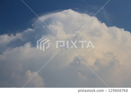 A developed cumulonimbus cloud approaches the tropopause and is about to become an anvil. A developed cumulonimbus cloud approaches the tropopause and is about to become an anvil. 129808768