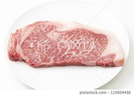 Steak meat on a white plate White background Steak meat on a white plate White background 129809486