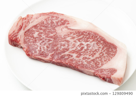 Steak meat on a white plate White background Steak meat on a white plate White background 129809490