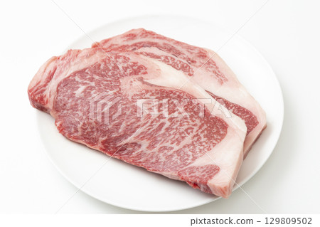 Steak meat on a white plate White background 129809502