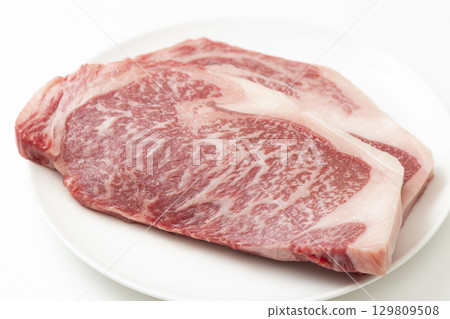 Steak meat on a white plate White background Steak meat on a white plate White background 129809508