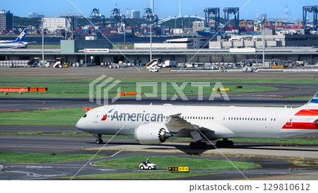 American Airlines plane taxiing down the runway 129810612