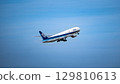 An ANA plane takes off into the blue sky 129810613