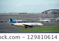 United Airlines plane taxiing down the runway 129810614