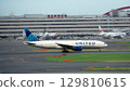 United Airlines plane taxiing down the runway 129810615