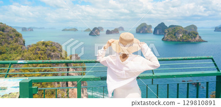 Woman tourist traveling in Krabi, Thailand. happy traveller enjoy and sightseeing view at koh Hong island viewpoint. summer trip, destination, Southeast Asia Travel, vacation and holiday concept 129810891