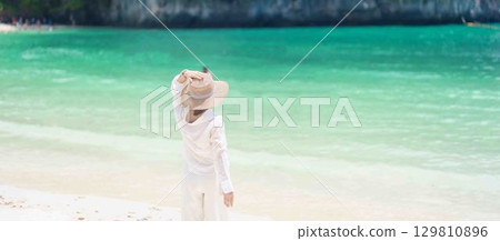 Woman tourist traveling and sightseeing in Krabi, Thailand. happy traveller enjoy on beach at koh Hong island. summer trip, destination, Southeast Asia Travel, vacation and holiday concept 129810896