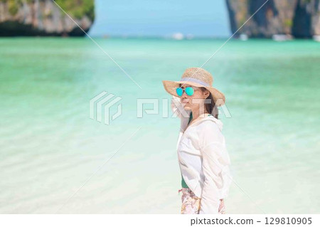 Woman tourist traveling and sightseeing in Krabi, Thailand, happy traveller enjoy at Maya Bay beach on Phi Phi island, Popular paradise island, destination, Southeast Asia Travel, vacation and holiday Woman tourist traveling and sightseeing in Krabi, Thailand, happy traveller enjoy at Maya Bay beach on Phi Phi island, Popular paradise island, destination, Southeast Asia Travel, vacation and holiday 129810905