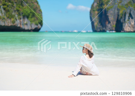 Woman tourist traveling and sightseeing in Krabi, Thailand, happy traveller enjoy at Maya Bay beach on Phi Phi island, Popular paradise island, destination, Southeast Asia Travel, vacation and holiday Woman tourist traveling and sightseeing in Krabi, Thailand, happy traveller enjoy at Maya Bay beach on Phi Phi island, Popular paradise island, destination, Southeast Asia Travel, vacation and holiday 129810906