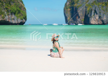 Woman tourist traveling and sightseeing in Krabi, Thailand, happy traveller enjoy at Maya Bay beach on Phi Phi island, Popular paradise island, destination, Southeast Asia Travel, vacation and holiday Woman tourist traveling and sightseeing in Krabi, Thailand, happy traveller enjoy at Maya Bay beach on Phi Phi island, Popular paradise island, destination, Southeast Asia Travel, vacation and holiday 129810913