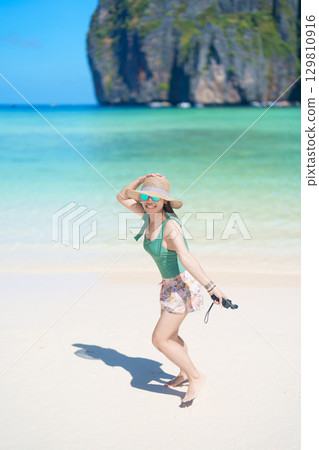 Woman tourist traveling and sightseeing in Krabi, Thailand, happy traveller enjoy at Maya Bay beach on Phi Phi island, Popular paradise island, destination, Southeast Asia Travel, vacation and holiday Woman tourist traveling and sightseeing in Krabi, Thailand, happy traveller enjoy at Maya Bay beach on Phi Phi island, Popular paradise island, destination, Southeast Asia Travel, vacation and holiday 129810916