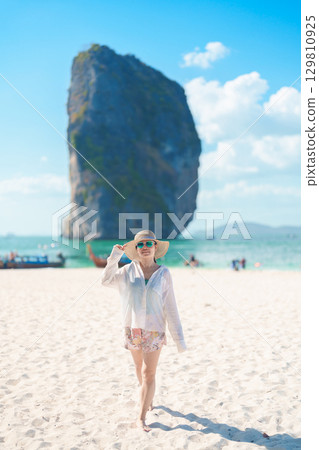 Woman tourist traveling and sightseeing in Krabi, Thailand. happy traveller enjoy on beach at Koh Poda island. summer trip, destination, Southeast Asia Travel, vacation and holiday concept Woman tourist traveling and sightseeing in Krabi, Thailand. happy traveller enjoy on beach at Koh Poda island. summer trip, destination, Southeast Asia Travel, vacation and holiday concept 129810925