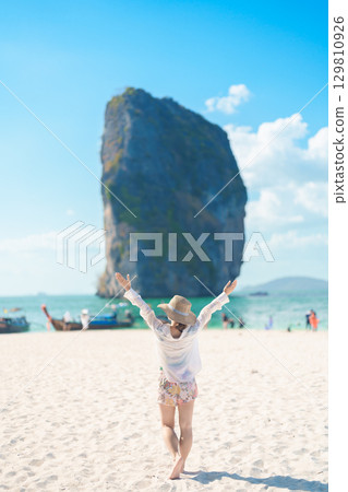 Woman tourist traveling and sightseeing in Krabi, Thailand. happy traveller enjoy on beach at Koh Poda island. summer trip, destination, Southeast Asia Travel, vacation and holiday concept Woman tourist traveling and sightseeing in Krabi, Thailand. happy traveller enjoy on beach at Koh Poda island. summer trip, destination, Southeast Asia Travel, vacation and holiday concept 129810926