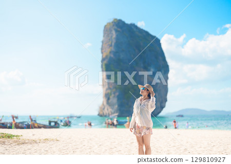 Woman tourist traveling and sightseeing in Krabi, Thailand. happy traveller enjoy on beach at Koh Poda island. summer trip, destination, Southeast Asia Travel, vacation and holiday concept Woman tourist traveling and sightseeing in Krabi, Thailand. happy traveller enjoy on beach at Koh Poda island. summer trip, destination, Southeast Asia Travel, vacation and holiday concept 129810927