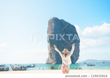 Woman tourist traveling and sightseeing in Krabi, Thailand. happy traveller enjoy on beach at Koh Poda island. summer trip, destination, Southeast Asia Travel, vacation and holiday concept Woman tourist traveling and sightseeing in Krabi, Thailand. happy traveller enjoy on beach at Koh Poda island. summer trip, destination, Southeast Asia Travel, vacation and holiday concept 129810928