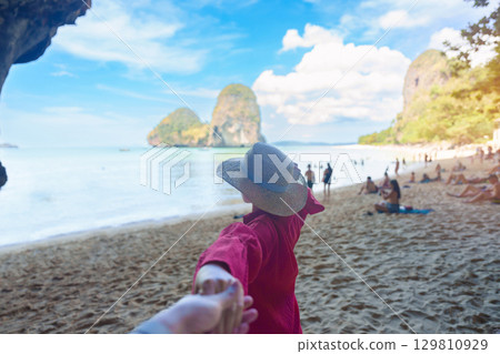 couple tourist travel and sightseeing in Krabi, Thailand. happy traveller enjoy on beach at Phra nang Cave Beach near Railay Beach. Honeymoon, tropical destination, Travel and summer vacation concept couple tourist travel and sightseeing in Krabi, Thailand. happy traveller enjoy on beach at Phra nang Cave Beach near Railay Beach. Honeymoon, tropical destination, Travel and summer vacation concept 129810929