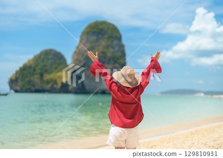 Woman tourist travel and sightseeing in Krabi, Thailand. happy traveller enjoy on beach at Phra nang Cave Beach near Railay Beach. summer trip, destination, Southeast Asia Travel and vacation concept 129810931