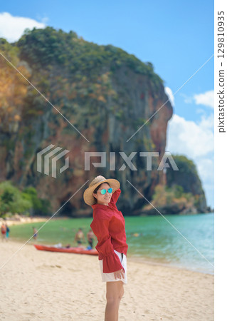 Woman tourist travel and sightseeing in Krabi, Thailand. happy traveller enjoy on beach at Phra nang Cave Beach near Railay Beach. summer trip, destination, Southeast Asia Travel and vacation concept Woman tourist travel and sightseeing in Krabi, Thailand. happy traveller enjoy on beach at Phra nang Cave Beach near Railay Beach. summer trip, destination, Southeast Asia Travel and vacation concept 129810935
