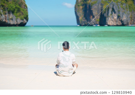 man tourist traveling and sightseeing in Krabi, Thailand, happy traveller enjoy at Maya Bay beach on Phi Phi island, Popular paradise island, destination, Southeast Asia Travel, vacation and holiday man tourist traveling and sightseeing in Krabi, Thailand, happy traveller enjoy at Maya Bay beach on Phi Phi island, Popular paradise island, destination, Southeast Asia Travel, vacation and holiday 129810940