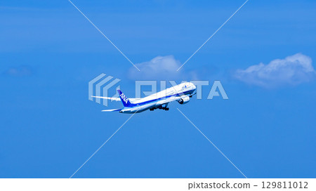 An ANA plane takes off into the blue sky An ANA plane takes off into the blue sky 129811012