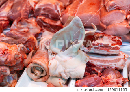 Pork laid out in showcase of butcher shop 129811165