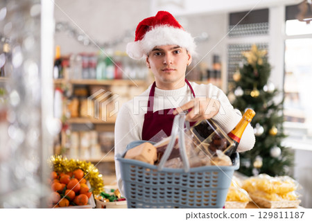 European guy seller stands in trading hall grocery, New Year Eve 129811187